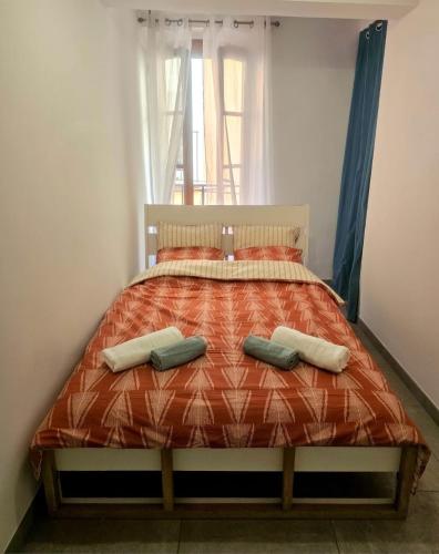 a bedroom with a bed with two pillows on it at Cozy haven in Venise Provençale in Martigues
