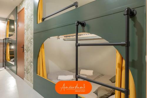 a bunk bed in a room with an orange sign at Amsterdam Group Villa 20 plus guests with Spa and Karaoke in Zwanenburg