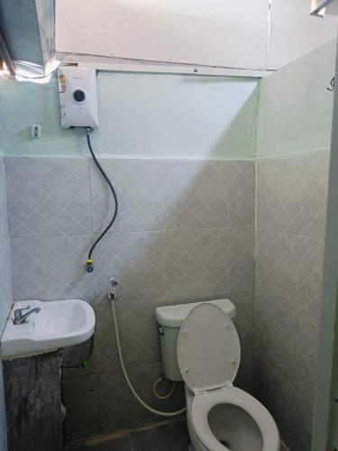 a small bathroom with a toilet and a sink at RoXx Social Hostel in Bangkok