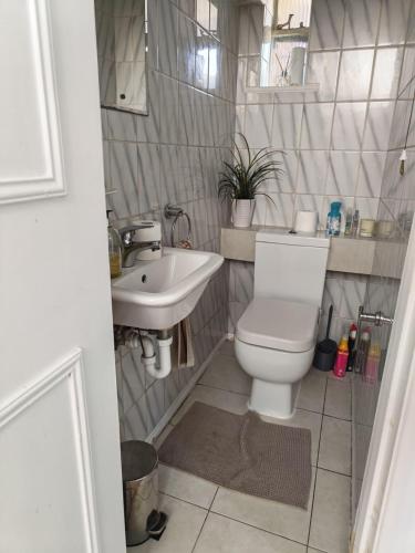 a bathroom with a toilet and a sink at Spacious Double Room with Shared Bathroom in London