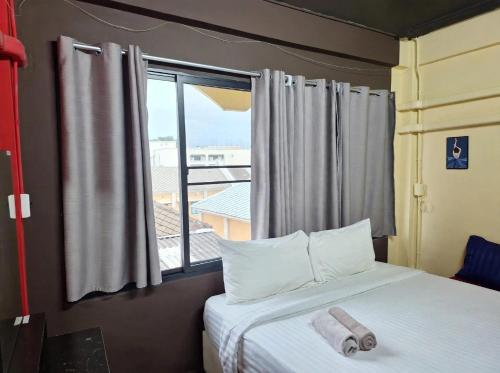 a bedroom with a bed with a large window at RoXx Social Hostel in Bangkok