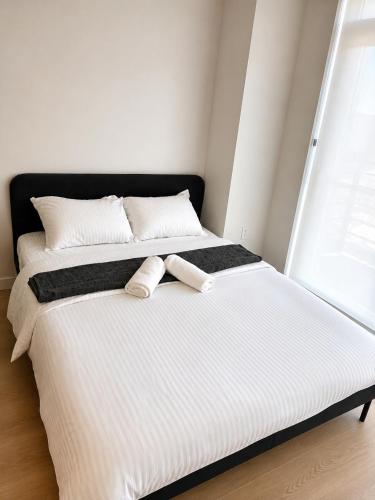 two beds sitting next to each other in a bedroom at Morden suite in Surrey