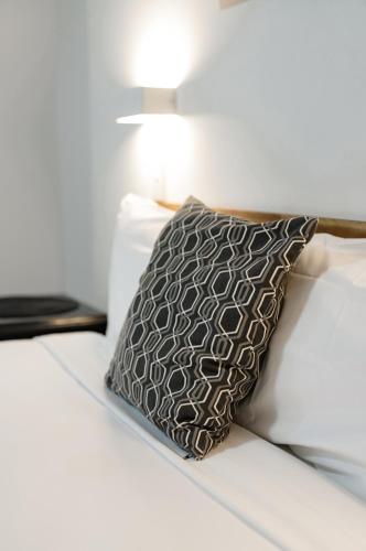 a black and white pillow sitting on top of a bed at Caboolture Gateway Motel in Caboolture