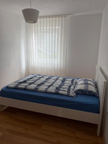 a bed in a room with a window at Ferienwohnung Olpe in Olpe