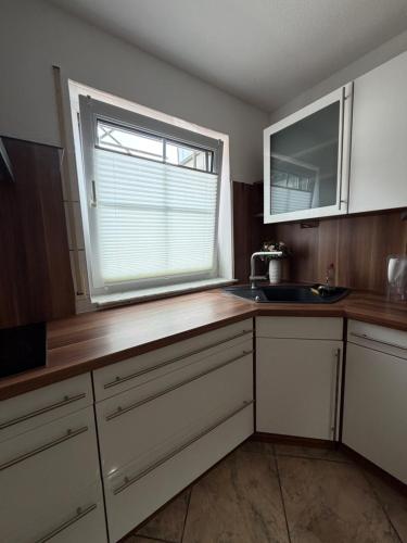 a kitchen with a sink and a window at Ferienwohnung Olpe in Olpe