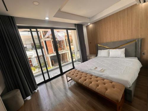 a bedroom with a large bed and a large window at Căn hộ Na Uy in Nha Trang