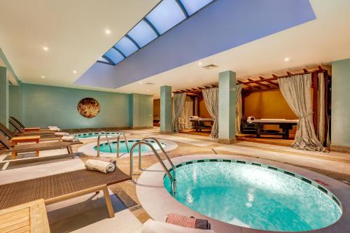 an indoor pool with a hot tub in a house at Antmare Hotel in Alacati