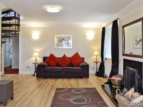 a living room with a couch and a fireplace at Burnbeag - Svve in Balloch