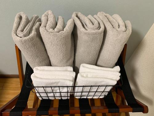 a basket filled with white towels on a table at リバーレインアクア in Kagoshima