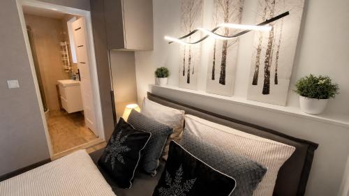 a living room with a couch and some pillows at Willa Apart 19A in Karpacz