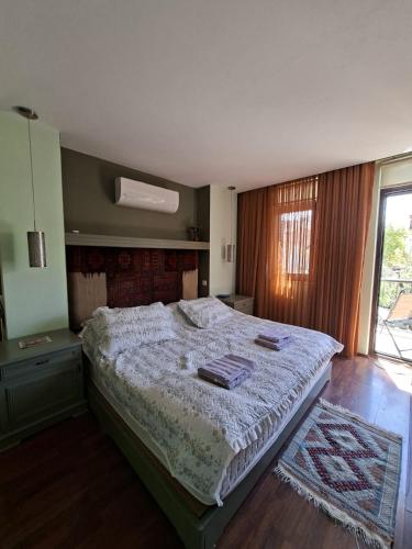 a bedroom with a bed in a room with a window at Miji Stay in Fethiye