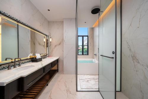a bathroom with a sink and a shower at Q.pavilion hotel in Baihe