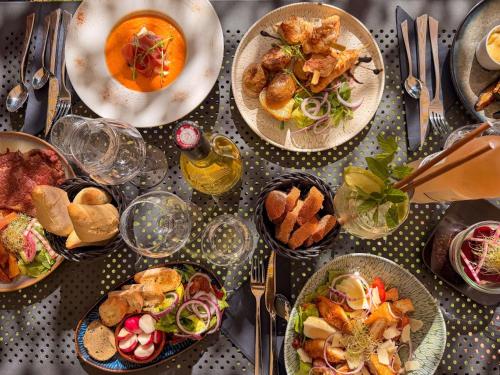 a table with many plates of food on it at ibis Nîmes Ouest - A9 in Nîmes