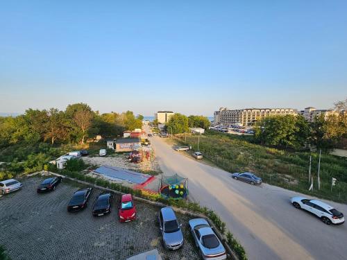 a group of cars parked in a parking lot at Beach apartments Ema in Kranevo