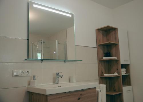 a bathroom with a sink and a mirror at Ferienhaus Allmunzen in Witzmannsberg