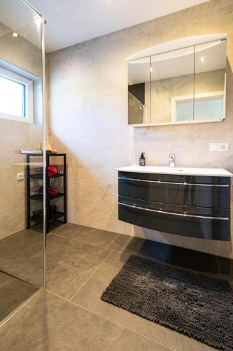 a bathroom with a sink and a mirror at Appartement Bergblick Eben in Eben im Pongau