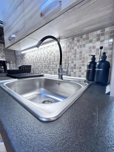 a kitchen counter with a sink in a kitchen at Apartmán Líšný - U Jizery in Líšný