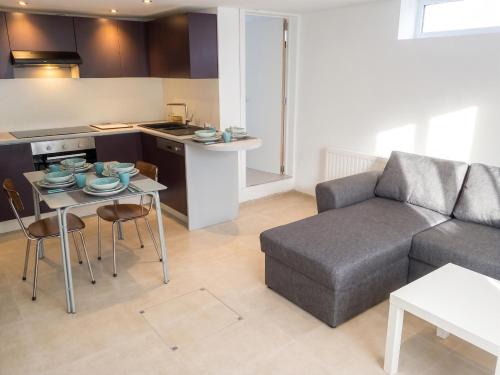 a living room with a couch and a table at Comfortable Apartment in Waterloo with Jacuzzi - 78m² in Waterloo