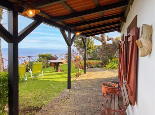 a patio with a view of the ocean from a house at Sea-view house in Fajã da Ovelha with garden and terrace in Fajã da Ovelha