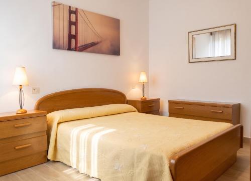a bedroom with a bed with a bridge picture on the wall at Welcoming Apartment in A Coruña, 90 m², Balcony in Serres