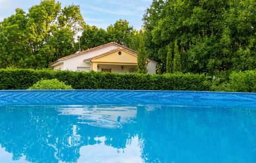 a house with a blue swimming pool in front of it at Charming Villa with Private Pool in La Calzada de Béjar in La Calzada de Béjar