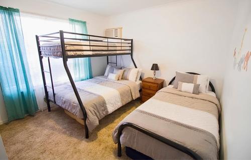 a bedroom with two bunk beds and a window at Manilla Cottage - Manilla NSW in Manilla