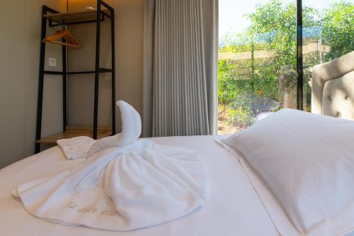 a white dress on a bed with a window at Futura 2 in Borgo