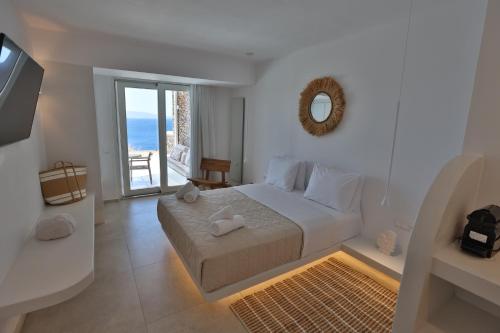 a bedroom with a bed with a view of the ocean at Three Drops in Kanala