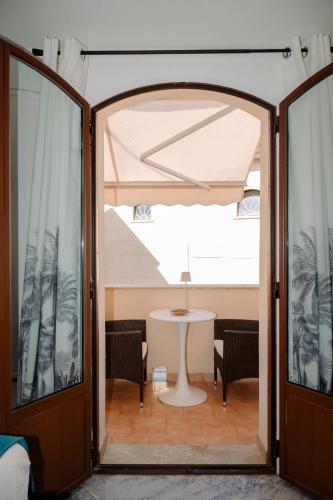 an open door to a room with a table at The Square - Luxury Apartment in Scilla
