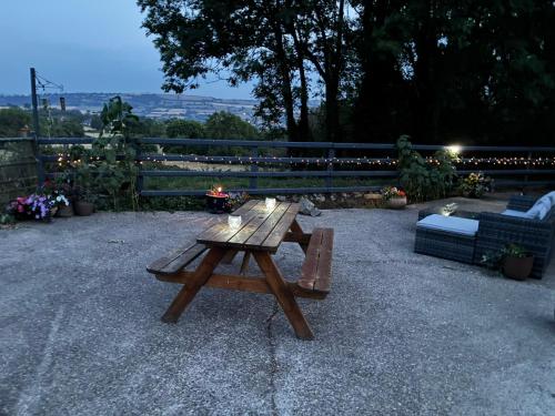 a wooden picnic table sitting on a patio at Hyssington Heights in Hyssington