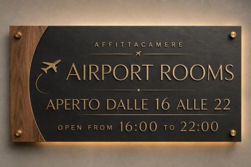 a sign for the entrance to the airport rooms at Airport Rooms - Bari in Bari