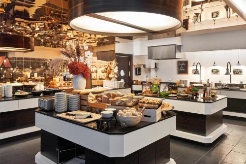 a kitchen with a counter with food on it at Radisson Blu Elizabete Hotel, Riga in Riga