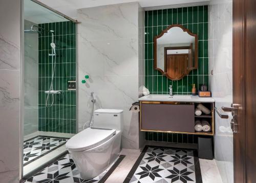 a bathroom with a toilet and a shower and a sink at Diamond Hotel Yen Bai in Yên Bái