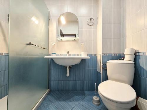 a bathroom with a toilet and a sink at Europroperties Yalta Apartments in Golden Sands