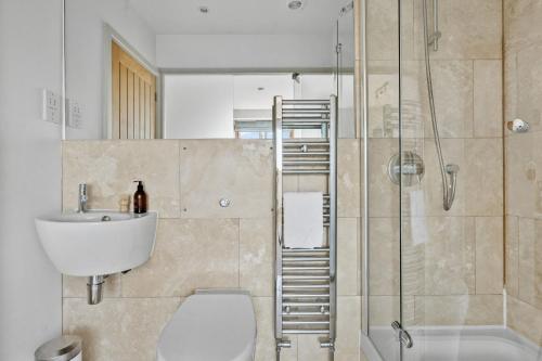 a bathroom with a toilet and a sink and a shower at Keepers Cottage - Dartmouth Golf and Spa Resort in Dartmouth