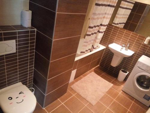 a bathroom with a toilet and a sink at Chopok Residence in Liptovský Mikuláš