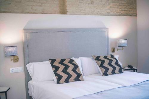 Un pat sau paturi într-o cameră la Casa Boutique La Pila del Pato