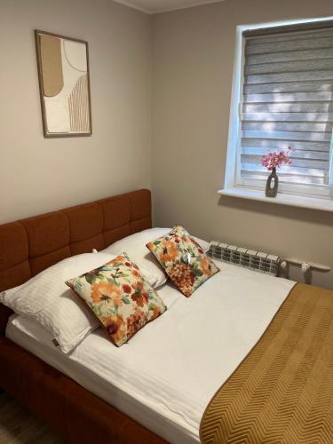 a bed with two pillows on it in a bedroom at Studio w centrum in Turek