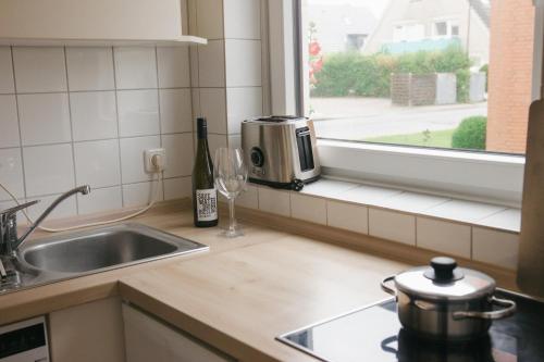 a kitchen counter with a sink and a window at Haus Isabel in Büsum