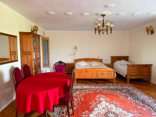 a bedroom with a bed and a table and chairs at Pokoje u Janeczki in Jałowo