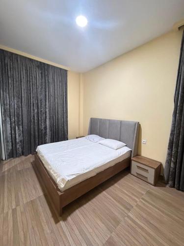 a bedroom with a bed and a large window at Kaprovani Sani Villa in Urekis Sadguri