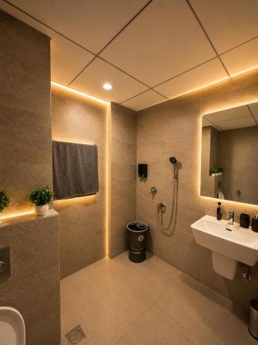 a bathroom with a sink and a toilet and a shower at Arya homestay in Greater Noida