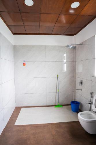 a bathroom with a toilet and a sink at Nohsngithiang Estate in Borpāni