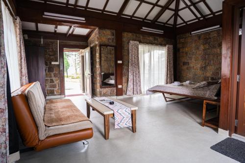 a living room with a couch and a table at Nohsngithiang Estate in Borpāni