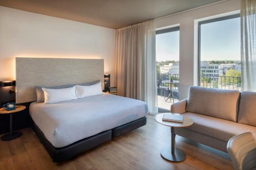 a hotel room with a bed and a couch at INNSiDE by Meliá Luxembourg in Luxembourg