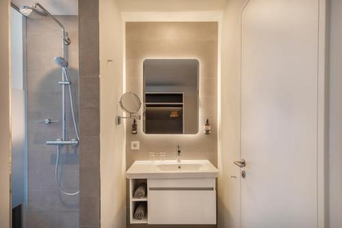 a bathroom with a sink and a shower at INNSiDE by Meliá Luxembourg in Luxembourg