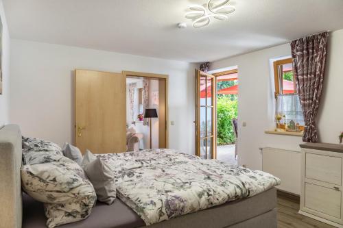 a bedroom with a bed and a ceiling fan at Haus Christian und Hanni in Bad Kohlgrub