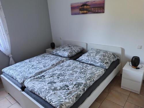 a bed with two pillows on it in a bedroom at Ferienwohnung Wagner mit Terrasse und Kinderspielplatz in Küps