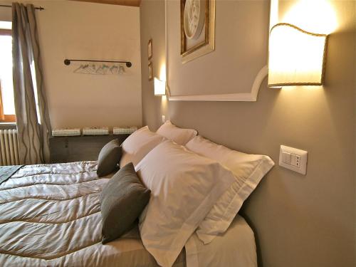a bedroom with a bed with pillows on it at Suite Umberto I in Assisi