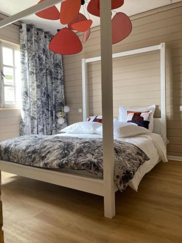 a bedroom with a canopy bed with red hearts on it at Villa Bourbon Pointu - Hiking & Spa in La Plaine des Palmistes